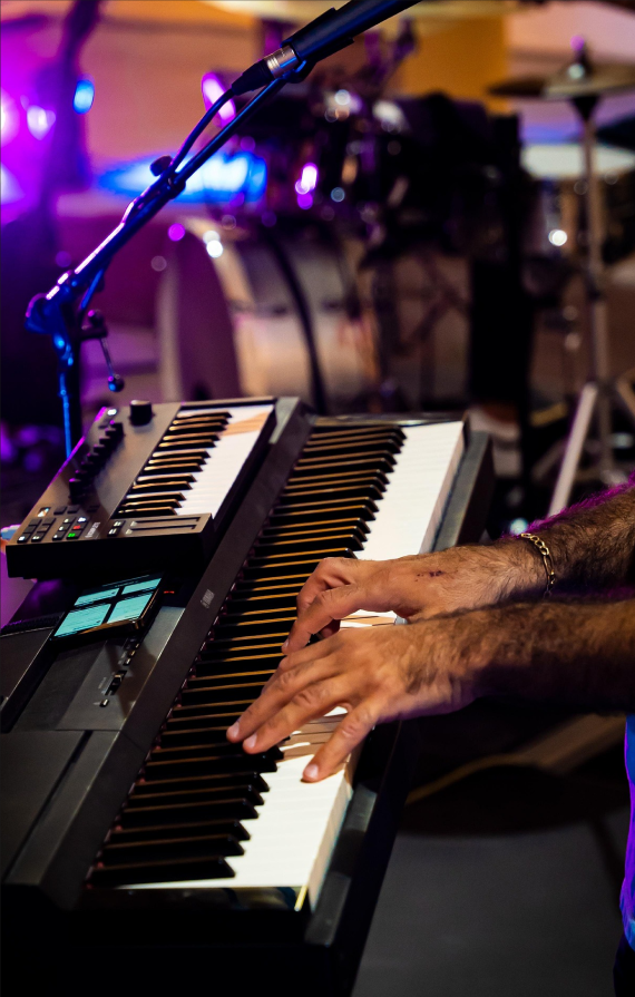 Two hands playing an electric keyboard